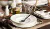 A table setting with plates, glasses, and condiments. Náhľad obrázku produktu