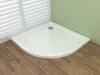 A white corner shower tray with a silver drain is shown in a bathroom setting with wooden flooring and white blinds. Produktbild-Vorschau