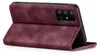 A burgundy flip case for a Samsung Galaxy A71 phone is shown from a diagonal angle, with the front cover open. Produktbild-Vorschau
