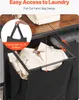A close-up view of a laundry basket with a pull-out fabric bag design, showing a hand lifting the bag. Podgląd zdjęcia produktu
