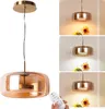 A collage showing a pendant lamp from different angles and lighting conditions, with a remote control. Anteprima dell’immagine prodotto