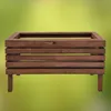 A wooden planter box is shown against a blurred green background. Anteprima dell’immagine prodotto