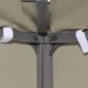 Close-up view of the corner joint of a beige canopy structure, showing metal framing and fabric attachment. Voir les images du produit