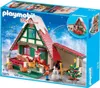 The image shows the packaging of a Playmobil Christmas house set, featuring a festive scene with Santa Claus, a snowman, and a Christmas tree. Produktbild-Vorschau