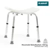 A white shower stool with adjustable height legs is shown against a white background. The brand logo 'KARAT' is in the top right corner, and text indicating maximum load capacity is at the bottom. Podgląd zdjęcia produktu