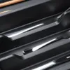 A close-up view of a black cutlery organizer with several silver utensils neatly arranged in separate compartments. Produktbild-Vorschau