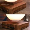 A close-up view of a floating moon lamp on a wooden base, showing details of the base and the lamp. Produktbild-Vorschau
