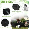 A detailed view of a black metal raised garden bed filled with plants, surrounded by gardening tools and decorative elements. Voir les images du produit