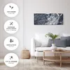 A modern living room scene with a white sofa, coffee table, and a piece of abstract art on the wall. Produktbild-Vorschau