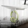 A white desk with a pair of green headphones hanging from a hook underneath. Anteprima dell’immagine prodotto