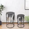 Two black metal side tables with leaf motifs and wooden tops are displayed in a room setting. Produktbild-Vorschau