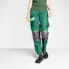 A person wearing work pants and shoes against a white background. Produktbild-Vorschau