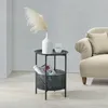 A side table with a vase and a glass of water next to a sofa. Produktbild-Vorschau