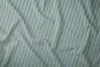 A close-up, top-down view of wrinkled mint-colored fabric with light gray stripes. Podgląd zdjęcia produktu