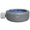 An inflatable hot tub filled with water, with a control unit attached to the side. Produktbild-Vorschau