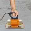 A hand holding a concrete vibrator over a wet concrete surface. Náhled obrázku produktu