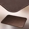 A close-up view of a metal baking sheet or oven floor plate, showing its textured surface and rounded edges. The image is split into two parts, with a detailed view of the corner at the top and a full view of the product at the bottom. Produktbild-Vorschau