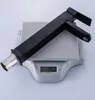 A black faucet is placed on a digital scale. Náhľad obrázku produktu
