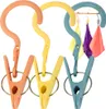Three colorful clothes clips with hooks are displayed against a white background. Anteprima dell’immagine prodotto