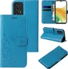 Multiple views of a blue flip phone case with floral and butterfly embossing. Produktbild-Vorschau
