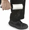A person is using a lint roller on their black pants. Anteprima dell’immagine prodotto