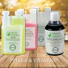 Several bottles of liquid supplements for chickens are displayed on a wooden surface with a blurred natural background. Produktbild-Vorschau