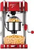 Eine rot-silberne Unold Popcornmaschine Retro mit frischem Popcorn darin, von dem etwas in eine durc Produktbild-Vorschau