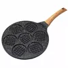 A top-down view of a waffle pan with a wooden handle, isolated on a white background. Produktbild-Vorschau