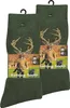 Two pairs of green hunting socks with deer antlers and a hunter with dogs depicted on the packaging. Produktbild-Vorschau