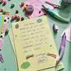 A handwritten letter with stickers and pens on a desk. Anteprima dell’immagine prodotto
