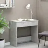 A desk with a book and a lamp on it, next to a plant and a chair. Podgląd zdjęcia produktu