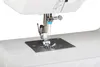 A close-up view of the needle and presser foot of a white sewing machine. Produktbild-Vorschau