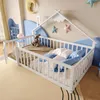 A child's bedroom with a white wooden house-shaped bed, decorated with stars and clouds on the wall. Podgląd zdjęcia produktu