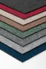 A stack of carpet tiles in various colors, arranged in a chevron pattern. Produktbild-Vorschau