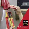 A hand is using a Wiha voltage and continuity tester on an electrical outlet. Náhľad obrázku produktu