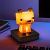 A Minecraft-themed fox icon light sits on a desk next to some books and a keyboard. Náhled obrázku produktu