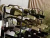 A wine rack filled with bottles of wine, with a wine glass in the foreground. Náhled obrázku produktu