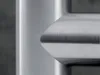 A close-up view of a brushed stainless steel surface with a corner detail. Podgląd zdjęcia produktu