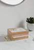 A wooden jewelry box with a white top and a small drawer sits on a marble surface. A golden bunny figurine is to the left, and a potted plant is in the background. Voir les images du produit