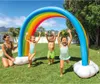 Children playing with a rainbow sprinkler in a backyard. Produktbild-Vorschau