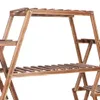 A close-up view of a wooden plant stand with multiple shelves. Anteprima dell’immagine prodotto