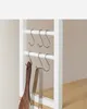 Close-up of kitchen utensils hanging on hooks on a shelf. Náhled obrázku produktu