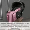 A pink knitted baby blanket draped over a car seat, which is placed on a stool. Produktbild-Vorschau