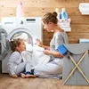 A mother and daughter are doing laundry together in a laundry room. Náhled obrázku produktu