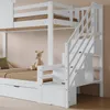 A close-up view of a white bunk bed with stairs that have built-in storage compartments. A stuffed giraffe is placed on the lower bunk. Náhled obrázku produktu