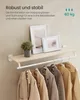 A wall-mounted shelf with a clothing rack below, showcasing coats. Produktbild-Vorschau