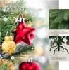 A close-up of a decorated artificial Christmas tree with text overlays highlighting features. Produktbild-Vorschau