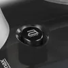 A close-up of a black button with a steam iron icon on a dark surface. Voir les images du produit
