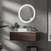 A modern bathroom vanity with a round, illuminated mirror above it. Produktbild-Vorschau