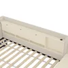 A close-up view of a beige upholstered bed frame with a built-in headboard featuring storage compartments and USB/Type-C ports. Anteprima dell’immagine prodotto